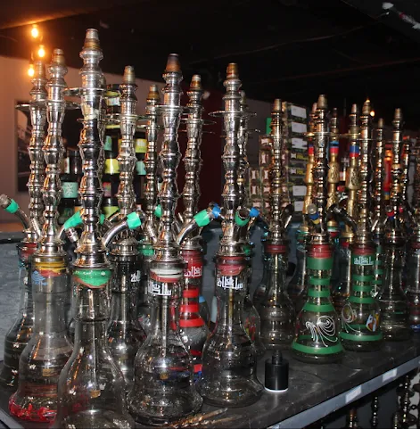Rows of hookah pipes lined up on the bar at Dose Shisha